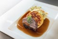 Roast deer, flat bread dumpling and round shaped cabbage vegetable with brown sauce and thyme garnish on a white plate, main Royalty Free Stock Photo