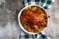 Roast duck with oranges, potatoes and herbs in a white baking dish on a dark grey background Royalty Free Stock Photo