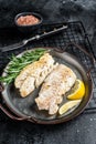 Roast Fillets of codfish, cooked cod fish meat. Black background. Top view