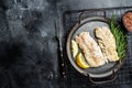 Roast Fillets of codfish, cooked cod fish meat. Black background. Top view. Copy space