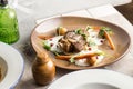 Roast Lamb leg with carrot, potato and pomegranate on brown plate on the table Royalty Free Stock Photo