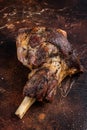 Roast Lamb leg with herbs and garlic. Dark background. Top view