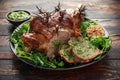 Roast Lamb leg with mint sauce, rosemary and garlic. on black plate, wooden table Royalty Free Stock Photo