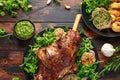 Roast Lamb leg with mint sauce, rosemary and garlic. on black plate, wooden table Royalty Free Stock Photo