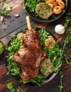 Roast Lamb leg with mint sauce, rosemary and garlic. on black plate, wooden table Royalty Free Stock Photo