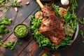 Roast Lamb leg with mint sauce, rosemary and garlic. on black plate, wooden table Royalty Free Stock Photo