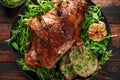 Roast Lamb leg with mint sauce, rosemary and garlic. on black plate, wooden table Royalty Free Stock Photo