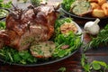 Roast Lamb leg with mint sauce, rosemary and garlic. on black plate, wooden table Royalty Free Stock Photo