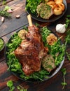 Roast Lamb leg with mint sauce, rosemary and garlic. on black plate, wooden table Royalty Free Stock Photo