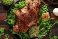 Roast Lamb leg with mint sauce, rosemary and garlic. on black plate, wooden table Royalty Free Stock Photo