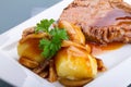 Roast pork with gravy and potatoes Royalty Free Stock Photo