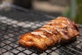 Roast pork neck on the stove with charcoal from wood Royalty Free Stock Photo