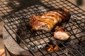 Roast pork neck on the stove with charcoal from wood Royalty Free Stock Photo