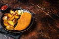 Roast pork schnitzel with fried potato, cooked meat steak. Dark background. Top view. Copy space Royalty Free Stock Photo