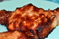 Roast pork steak with bone on a plate background