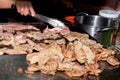 Roast pork on the stove, prepared by the seller, sold to the buyer Royalty Free Stock Photo