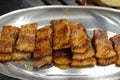 Roast Pork topped with apple sauce on the stainless steel plate.