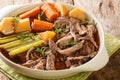 Roast pot of slow cooked beef with vegetables in a spicy sauce close-up in a frying pan. horizontal Royalty Free Stock Photo