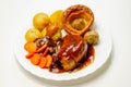 Roast potatoes and roast chicken breast in a chicken and white wine gravy with peas, carrots, pork and onion stuffing and a Royalty Free Stock Photo