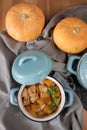 Pumpkin roast in a blue pan on a wooden table Royalty Free Stock Photo