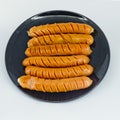 Roast sausages on black dish