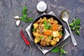 Roast, stewed beef with potatoes and carrots in a brown clay bowl Royalty Free Stock Photo