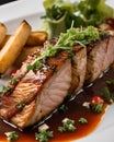 roast tuna with french fries on a white plate close-up.