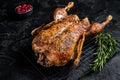 Roast whole duck, festive christmas recipe. Black background. Top view