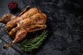 Roast whole duck, festive christmas recipe. Black background. Top view. Copy space