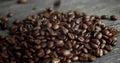 Roasted arabica coffee beans scattered on a wooden table. Fresh coffee beans. Espresso, americano, doppio, cappuccino