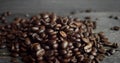 Roasted arabica coffee beans scattered on a wooden table. Fresh coffee beans. Espresso, americano, doppio, cappuccino
