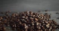 Roasted arabica coffee beans scattered on a wooden table. Fresh coffee beans. Espresso, americano, doppio, cappuccino