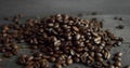 Roasted arabica coffee beans scattered on a wooden table. Fresh coffee beans. Espresso, americano, doppio, cappuccino