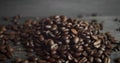 Roasted arabica coffee beans scattered on a wooden table. Fresh coffee beans. Espresso, americano, doppio, cappuccino