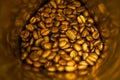 Roasted aroma whole oval coffee beans on metallic jar for sweet morning Royalty Free Stock Photo