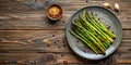Roasted asparagus on rustic wooden table with spices. Generative AI Royalty Free Stock Photo