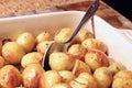 Roasted baby potatoes out of the oven with a spoon Royalty Free Stock Photo
