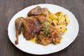Roasted or baked Guinea fowl served with baked potatoes and sweet onion with apples and raisins. Royalty Free Stock Photo