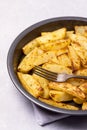 Roasted or Baked Potatoes With Spice in Black Bowl on Light Gray Background Tasty Homemade Dish Dinner Grilled Potatoes Vertical