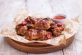 Roasted barbecue chicken wings with bbq sauce, italian herbs, olive oil and pepper Royalty Free Stock Photo