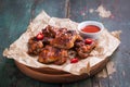 Roasted barbecue chicken wings with bbq sauce, italian herbs, olive oil and pepper Royalty Free Stock Photo