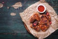 Roasted barbecue chicken wings with bbq sauce, italian herbs, olive oil and pepper