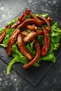 Roasted barbecue hot pork ribs served on stone board with vegetable Royalty Free Stock Photo