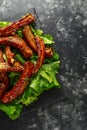 Roasted barbecue hot pork ribs served on stone board with vegetable Royalty Free Stock Photo