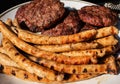 Roasted Bbq Sausages With Grillmarks And Grilled Homemade Meat BBQ Burgers For Hamburger On Plate.