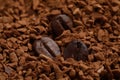 Roasted beans on instant coffee, closeup view Royalty Free Stock Photo