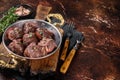 Roasted beef kidney, offal meat in skillet with herbs. Dark background. Top view. Copy space Royalty Free Stock Photo