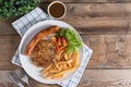 Roasted beef meat steak and sausage with french fries. Royalty Free Stock Photo