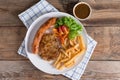 Roasted beef meat steak and sausage with french fries. Top view. Royalty Free Stock Photo