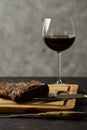 Roasted beef ribs with a glass of red wine presented on the table, traditional Argentine cuisine, Asado barbecue,